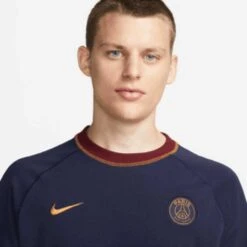 Nike Men's Paris Saint-Germain Travel Short Sleeve Soccer Top - Blackened Blue/Team Red/Gold Suede -Optimal Sportswear Store download 22 4c36b34d 2a70 4a19 b17b 163c75ba01ec